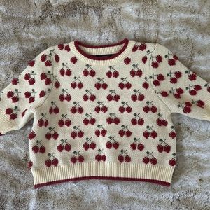 Cropped cherry pattern sweater.